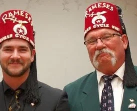 Two people wearing Shriners headwear